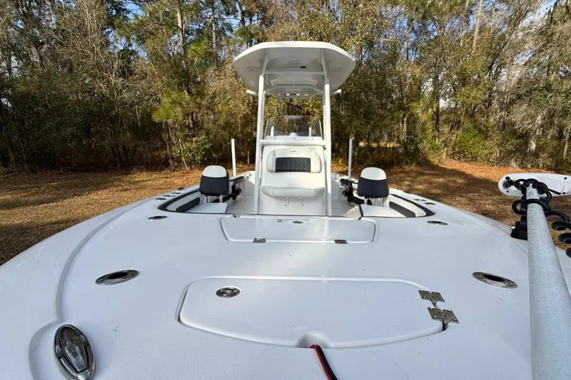 Slide: The Image of 2024 Tidewater 2300 Carolina Bay boat, white deck, forest background. - 37