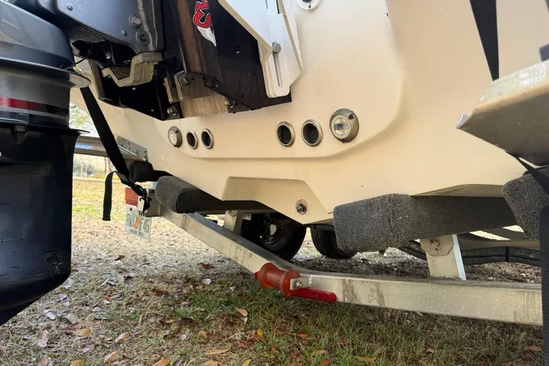 Slide: The Image of 2024 Tidewater 2300 Carolina Bay boat on trailer, showing engine and hull details. - 38