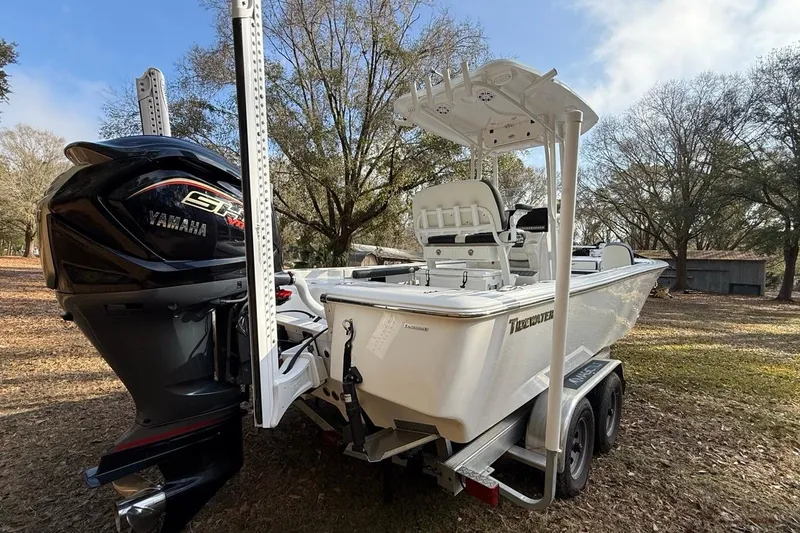 Slide: The Image of 2024 Tidewater 2300 Carolina Bay boat with Yamaha engine on trailer, parked outdoors. - 6
