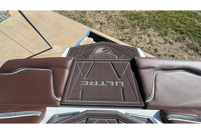 Slide: The Image of 2026 Tigé Ultré 25ZX boat interior with brown leather seating and stylish design. - 11