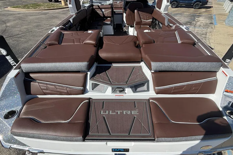 Slide: The Image of 2026 Tigé Ultré 25ZX boat interior with luxurious brown seating and modern design. - 13