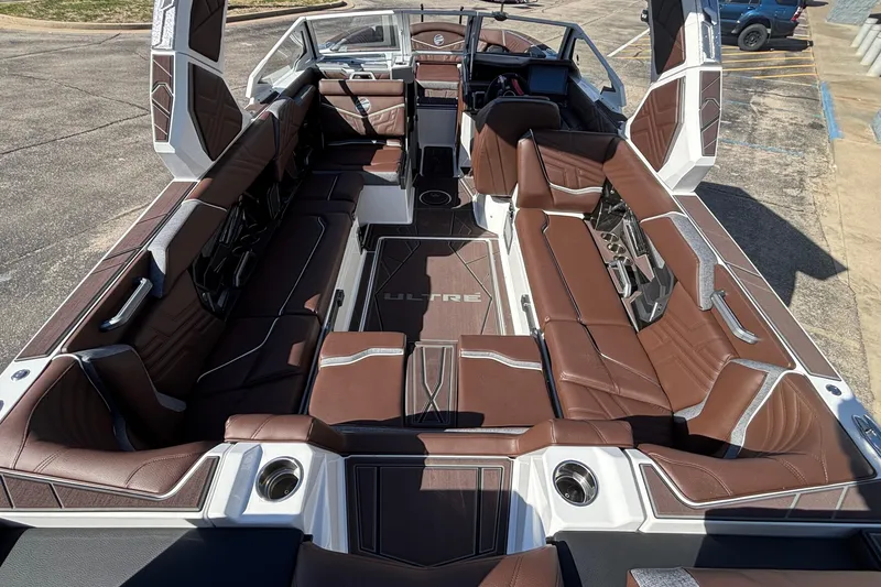 Slide: The Image of 2026 Tigé Ultré 25ZX boat interior with luxurious brown seating and modern design. - 19