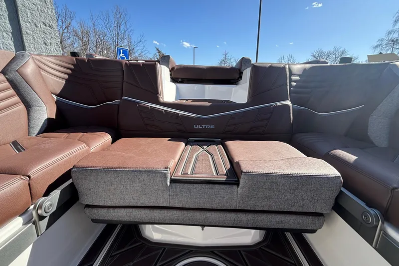 Slide: The Image of 2026 Tigé Ultré 25ZX boat interior with luxurious brown and gray seating. - 20