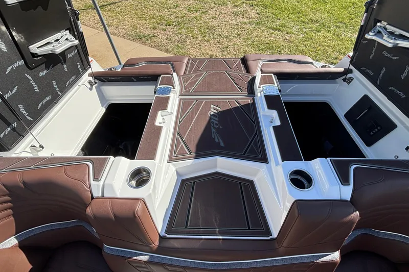 Slide: The Image of 2026 Tigé Ultré 25ZX boat interior with brown leather seats and storage compartments. - 22