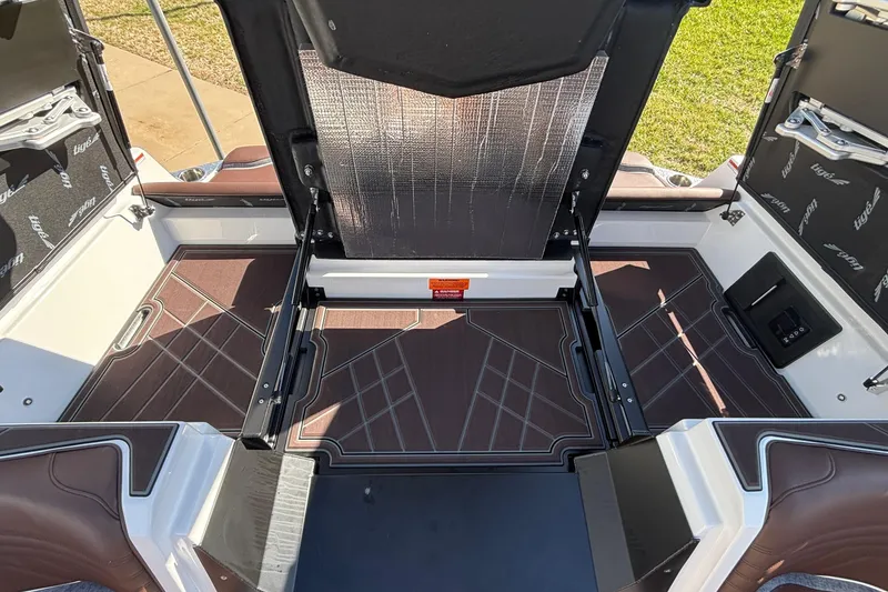 Slide: The Image of 2026 Tigé Ultré 25ZX boat interior with open storage compartment. - 28