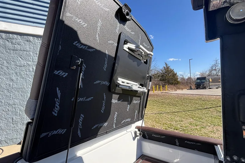 Slide: The Image of 2026 Tigé Ultré 25ZX boat interior detail with branded upholstery and storage compartment. - 30