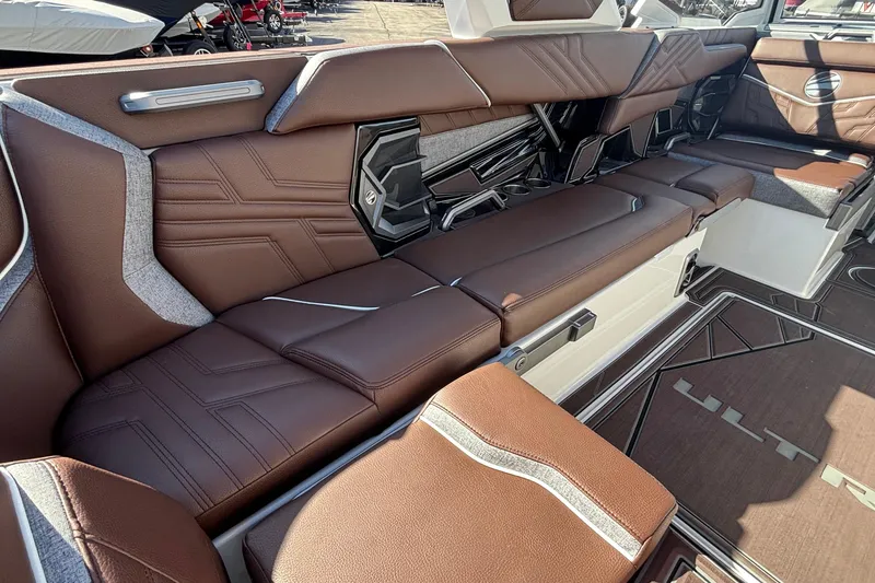 Slide: The Image of Luxurious interior seating of 2026 Tigé Ultré 25ZX boat with brown leather upholstery. - 37