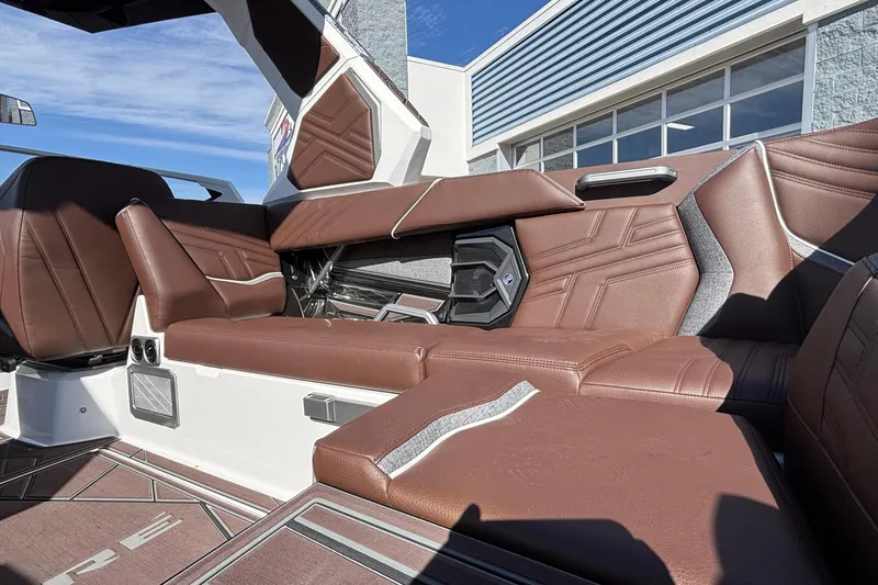 Slide: The Image of 2026 Tigé Ultré 25ZX boat interior with brown leather seating and modern design. - 39