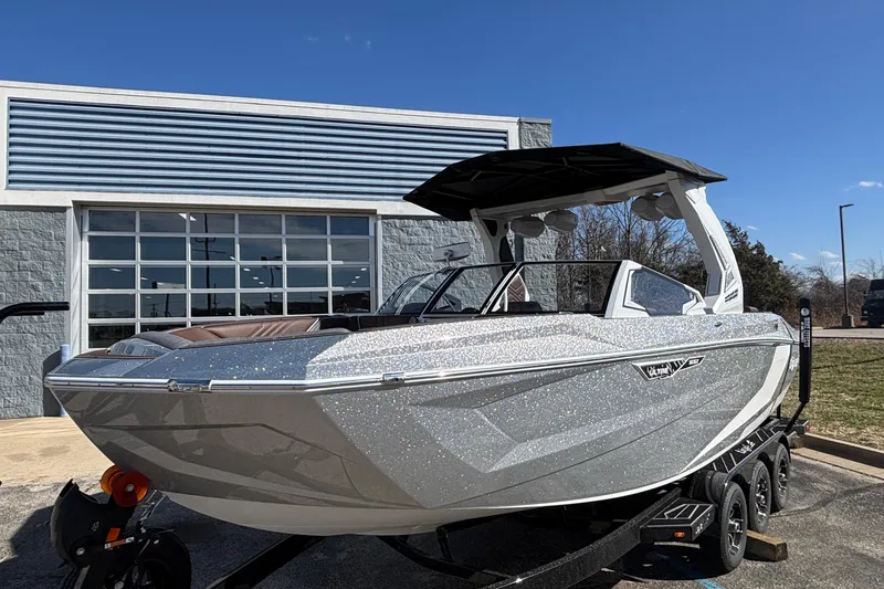 Slide: The Image of 2026 Tigé Ultré 25ZX boat with sleek design, parked outdoors on a sunny day. - 4
