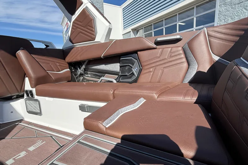 Slide: The Image of 2026 Tigé Ultré 25ZX boat interior with brown leather seating and modern design. - 40