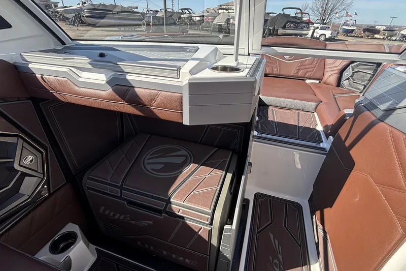 Slide: The Image of 2026 Tigé Ultré 25ZX boat interior with brown leather seating and modern design. - 46