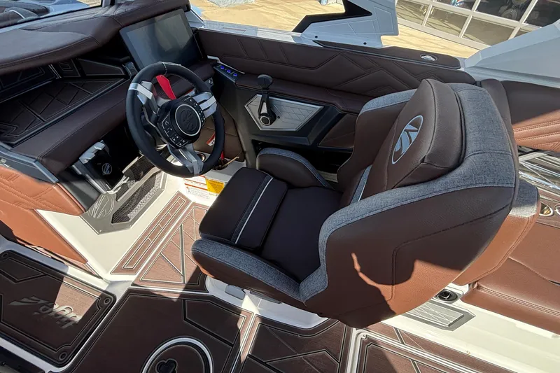 Slide: The Image of 2026 Tigé Ultré 25ZX boat interior with luxurious captain's seat and modern steering wheel. - 47