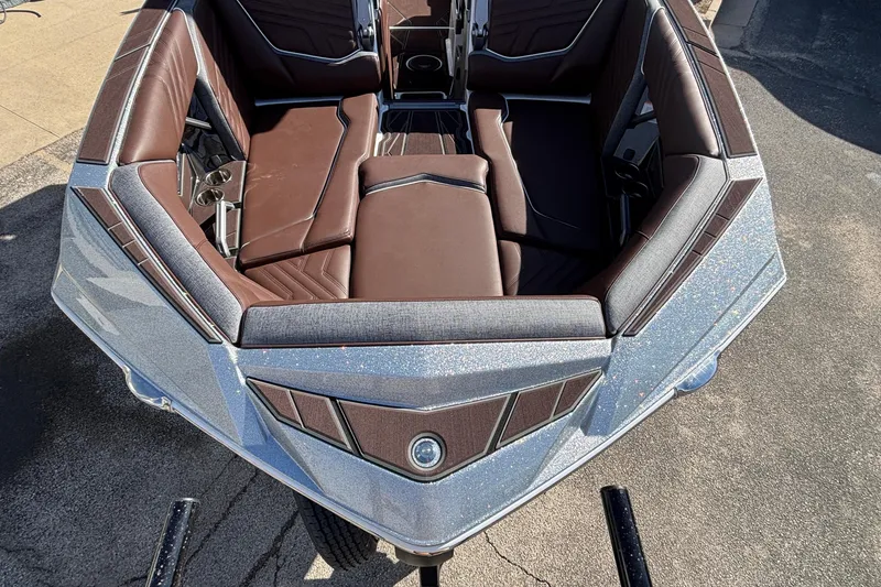 Slide: The Image of 2026 Tigé Ultré 25ZX boat interior with brown seating and sleek design. - 5