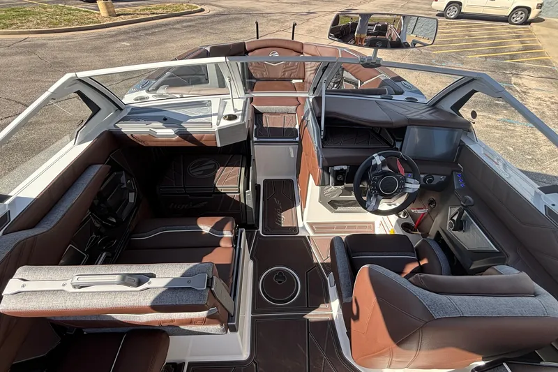 Slide: The Image of Interior of 2026 Tigé Ultré 25ZX boat, featuring luxurious seating and modern dashboard. - 51