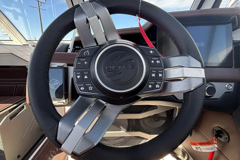 Slide: The Image of Steering wheel of 2026 Tigé Ultré 25ZX boat with control buttons. - 52