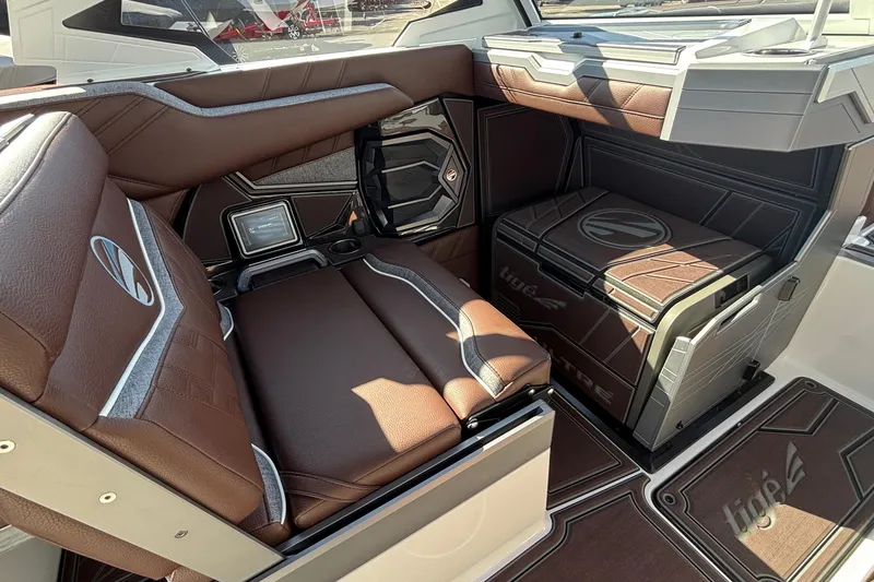 Slide: The Image of Luxurious interior of 2026 Tigé Ultré 25ZX boat with brown leather seating. - 53