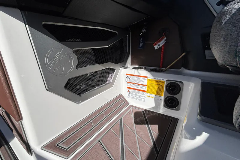 Slide: The Image of Interior of 2026 Tigé Ultré 25ZX boat with speaker and safety labels. - 57