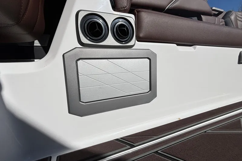Slide: The Image of 2026 Tigé Ultré 25ZX interior detail with cup holders and brown leather seating. - 60