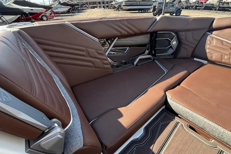 Slide: The Image of Luxurious interior of 2026 Tigé Ultré 25ZX boat with brown leather seating. - 65