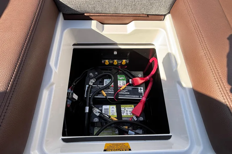 Slide: The Image of Battery compartment of 2026 Tigé Ultré 25ZX boat, featuring dual batteries and wiring. - 70