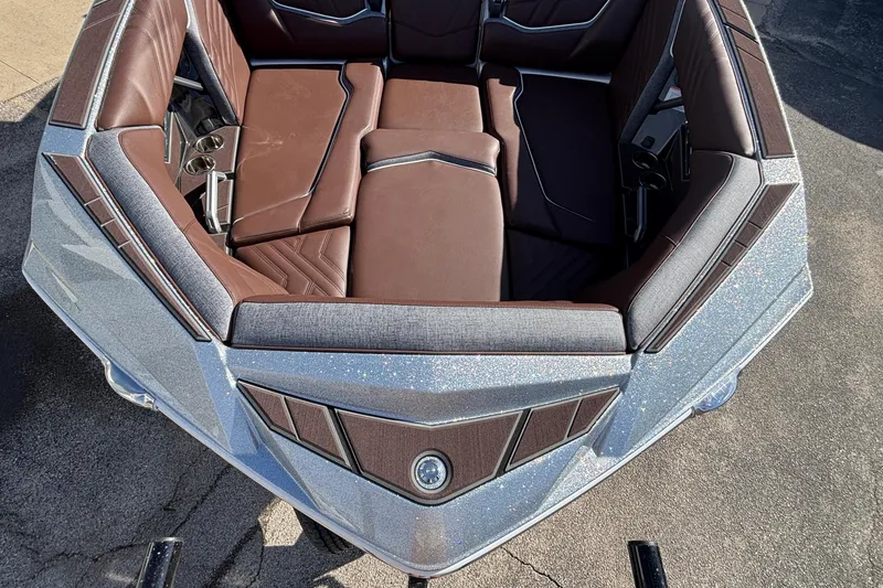 Slide: The Image of 2026 Tigé Ultré 25ZX boat interior with luxurious brown seating and cup holders. - 71