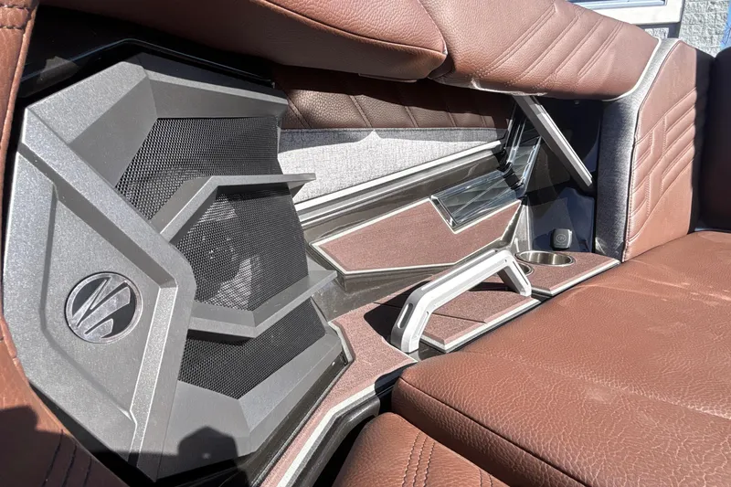 Slide: The Image of 2026 Tigé Ultré 25ZX boat interior with brown leather seats and modern speaker design. - 75