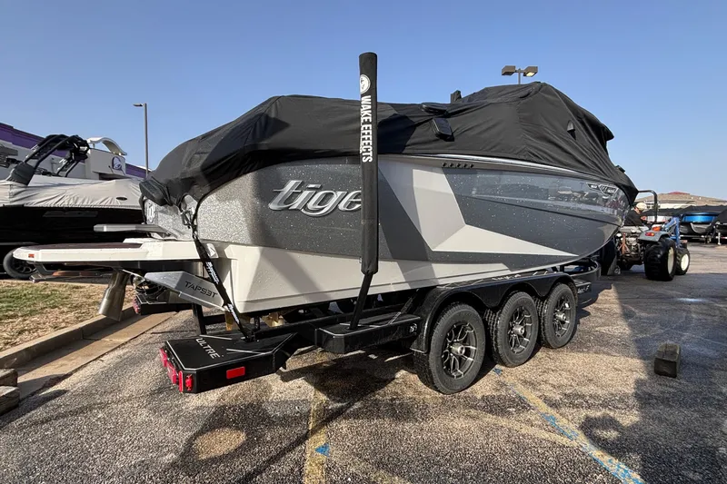 Slide: The Image of 2026 Tigé Ultré 25ZX boat on trailer, covered, parked outdoors. - 87
