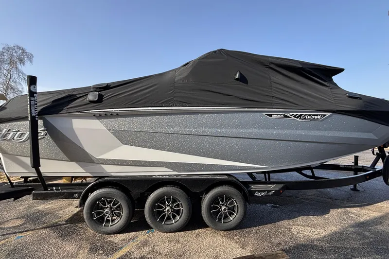 Slide: The Image of 2026 Tigé Ultré 25ZX boat with cover on trailer, side view. - 88