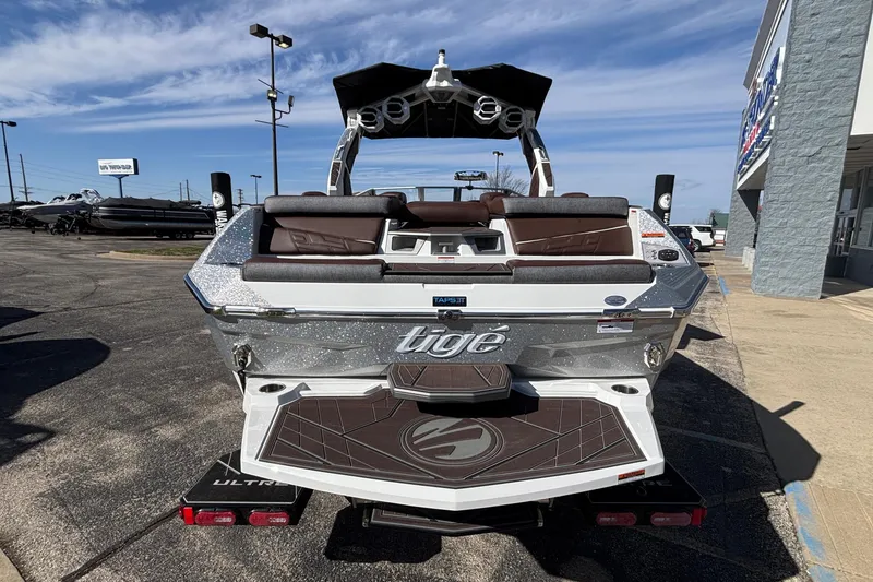 Slide: The Image of 2026 Tigé Ultré 25ZX boat with sleek design and modern features, parked outdoors. - 92