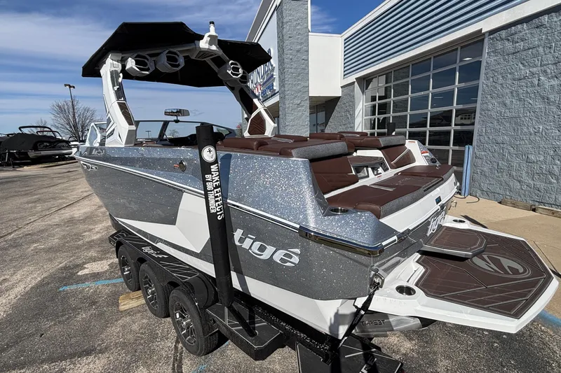 Slide: The Image of 2026 Tigé Ultré 25ZX boat on trailer, parked outside a building. - 93