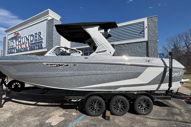 Slide: The Image of 2026 Tigé Ultré 25ZX boat at Big Thunder Marine, sparkling silver exterior. - 94
