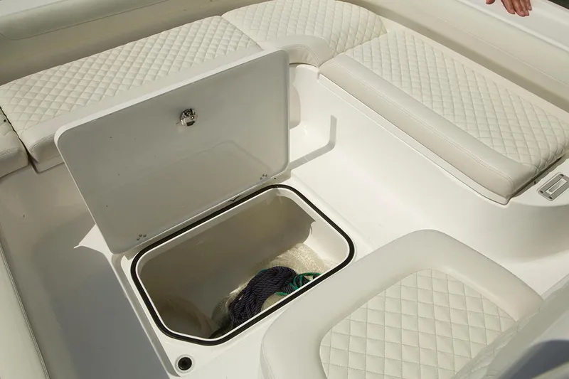 Slide: The Image of Manufacturer Provided Image: 2026 Caymas 26 HB boat interior with open storage compartment and quilted seating. - 10