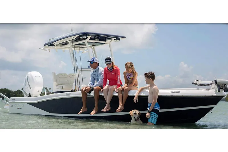 Slide: The Image of Manufacturer Provided Image: 2026 Caymas 26 HB boat with family and dog enjoying a sunny day on the water. - 4