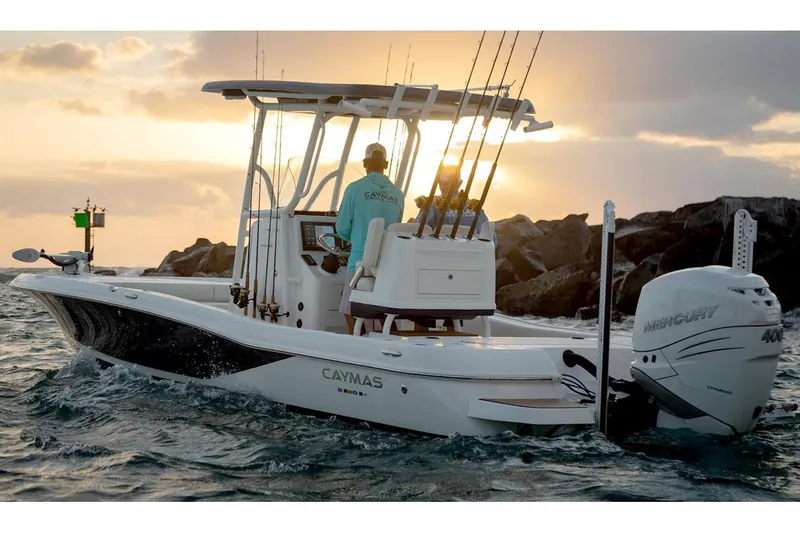 Slide: The Image of Manufacturer Provided Image: 2026 Caymas 26 HB boat cruising at sunset with fishing gear and Mercury engine. - 5