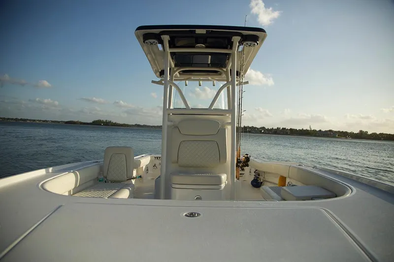 Slide: The Image of Manufacturer Provided Image: 2026 Caymas 26 HB boat on calm water, showcasing sleek design and spacious deck. - 7