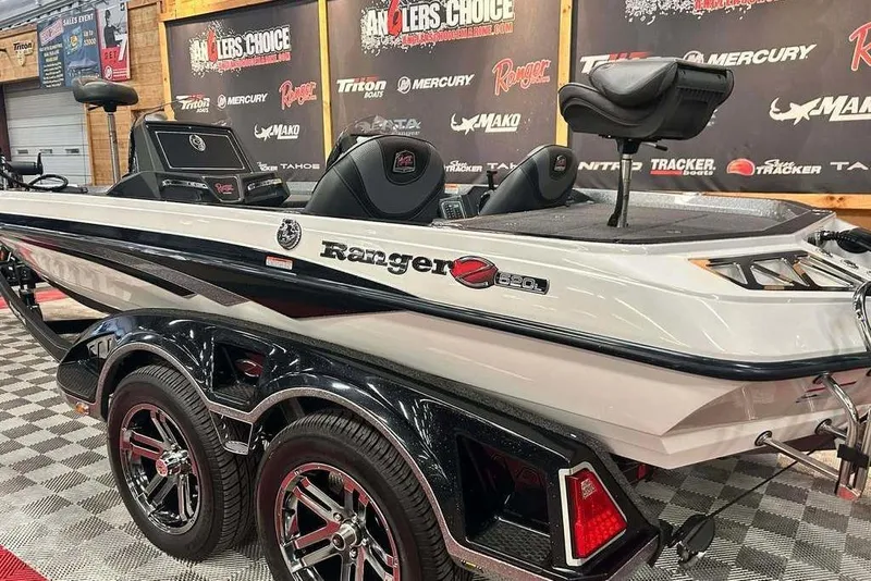 Slide: The Image of 2018 Ranger Z520L boat on display with branded backdrop and dual-axle trailer. - 3