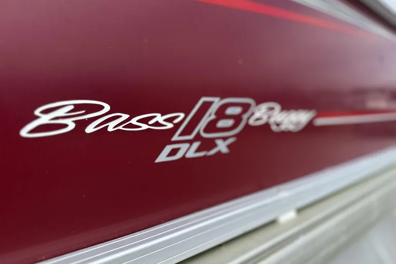 Slide: The Image of 2018 Sun Tracker Bass Buggy 18 DLX logo on maroon surface. - 4