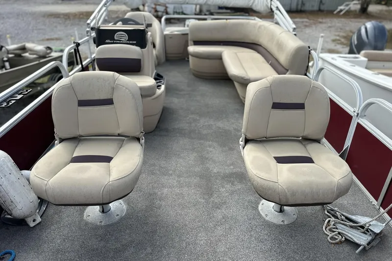 Slide: The Image of 2018 Sun Tracker Bass Buggy 18 DLX pontoon boat with beige seating and spacious layout. - 5