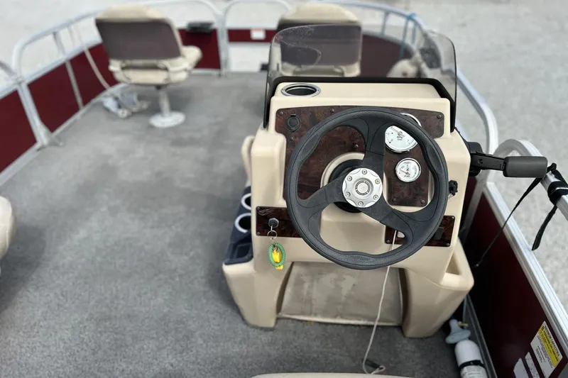 Slide: The Image of 2018 Sun Tracker Bass Buggy 18 DLX pontoon boat interior with steering console and seating. - 7