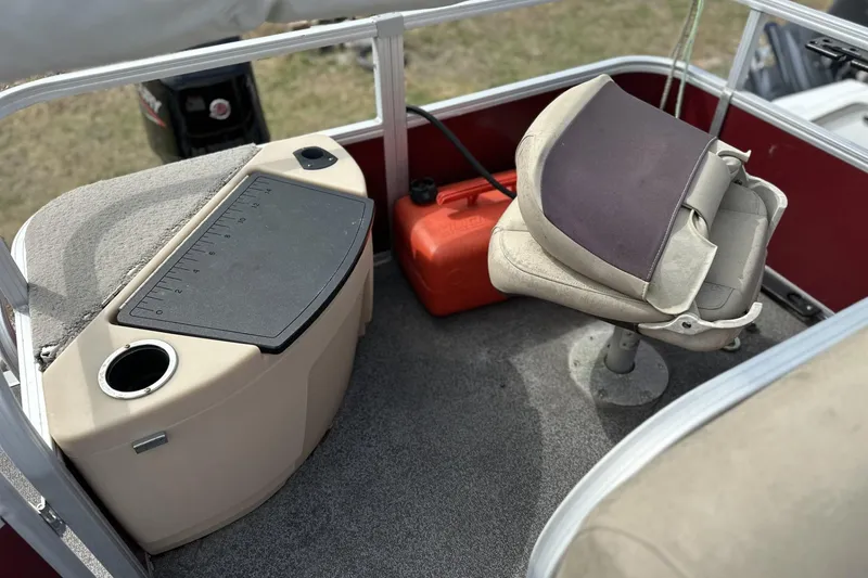 Slide: The Image of 2018 Sun Tracker Bass Buggy 18 DLX interior with fishing seat and storage area. - 8