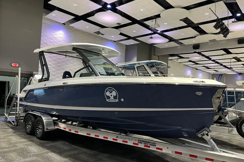 The Image of 2026 Monterey Elite 27 OB boat displayed indoors on a trailer. - 0
