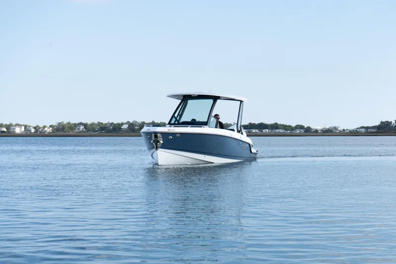 Slide: The Image of 2026 Monterey Elite 27 OB boat cruising on calm waters. - 10