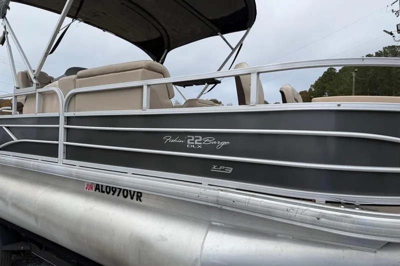 Slide: The Image of 2019 Sun Tracker Fishin' Barge 22 XP3 pontoon boat with beige seating and gray exterior. - 2