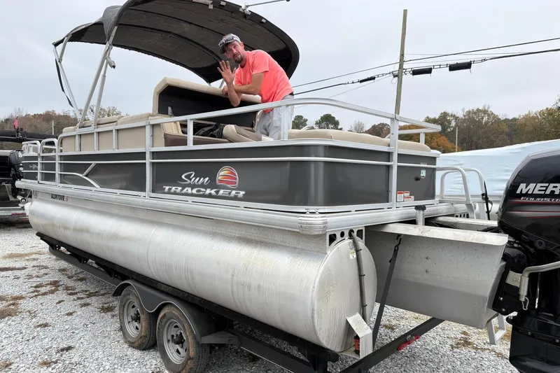 Slide: The Image of 2019 Sun Tracker Fishin' Barge 22 XP3 pontoon boat on trailer with canopy and Mercury engine. - 4
