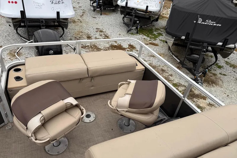 Slide: The Image of 2019 Sun Tracker Fishin' Barge 22 XP3 interior with beige seating and fishing chairs. - 6