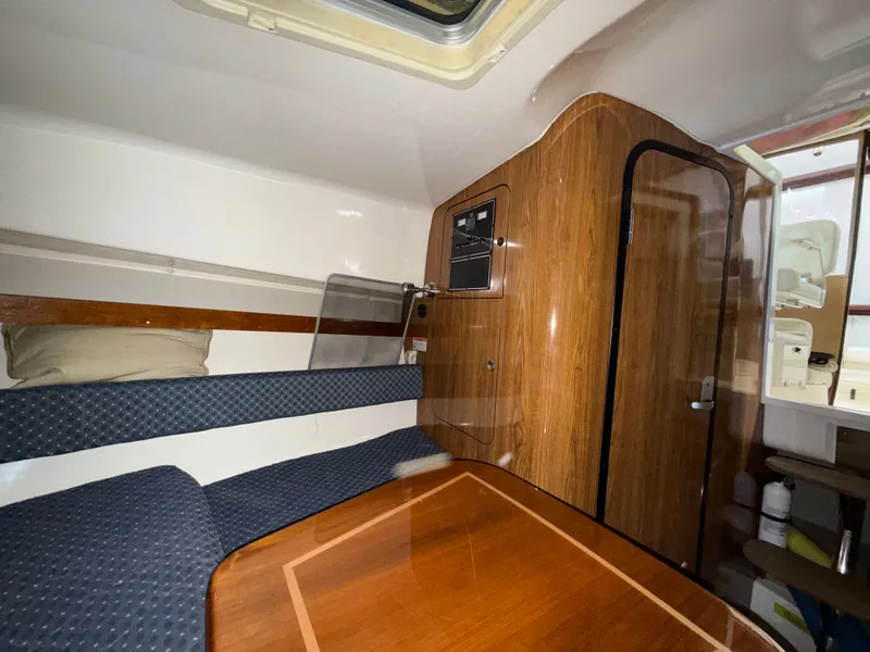 Slide: The Image of Interior of 2008 Pursuit OS 285 Offshore with wooden table and seating area. - 10