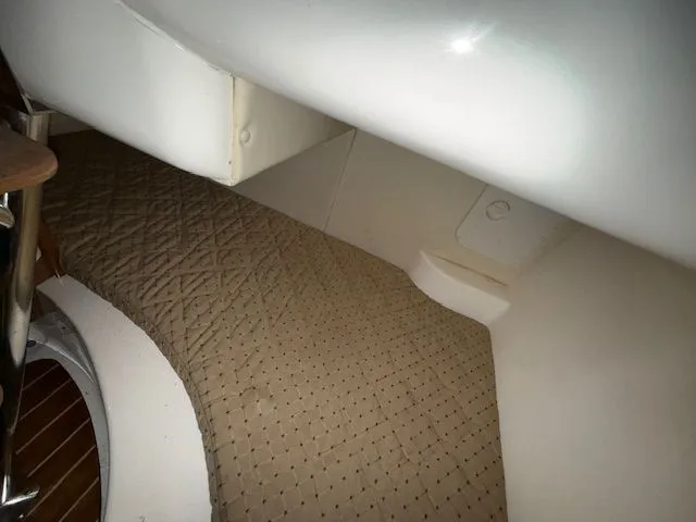 Slide: The Image of Interior of a 2008 Pursuit OS 285 Offshore with cushioned bed. - 15