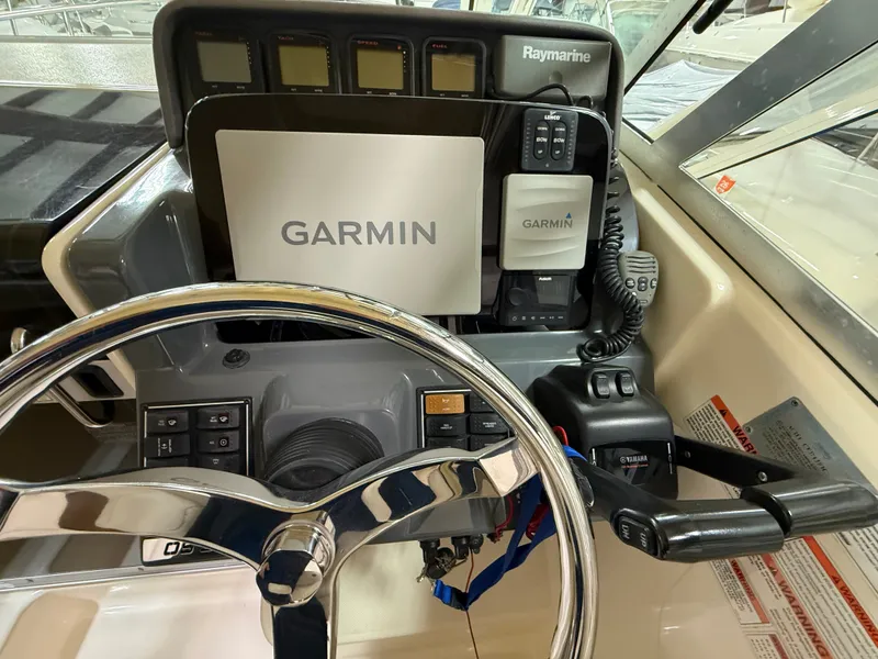 Slide: The Image of 2008 Pursuit OS 285 Offshore helm with Garmin and Raymarine electronics. - 7