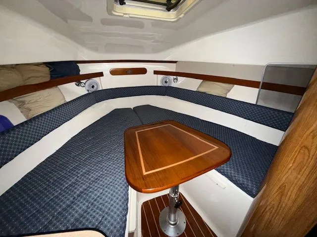 Slide: The Image of Interior of 2008 Pursuit OS 285 Offshore with wooden table. - 9