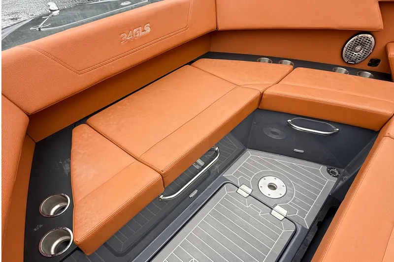 Slide: The Image of 2023 Cruisers Yachts 34 GLS OB interior with orange seating and cup holders. - 11